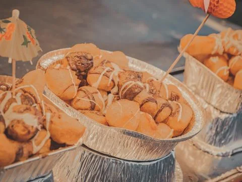 Small tiny donuts covered by chocolate at party Stock Photos