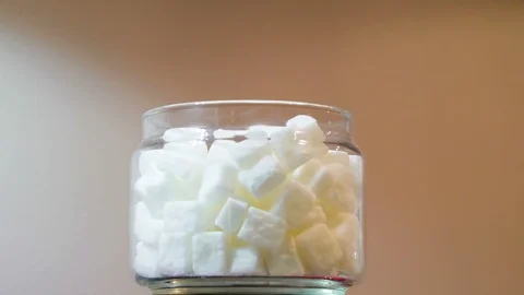 The small tiny sugar cubes inside the glass jar Video stock 102297772