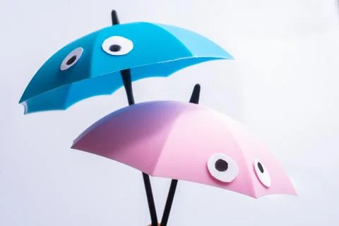 Small tiny umbrellas on white background Stock Photos