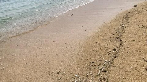 Small tiny waves lapped at the shore. Kondang Merak Beach in Malang Indonesia Stock Photos