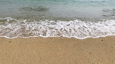 Small tiny waves lapped at the shore. Kondang Merak Beach in Malang Indonesia 스톡 사진