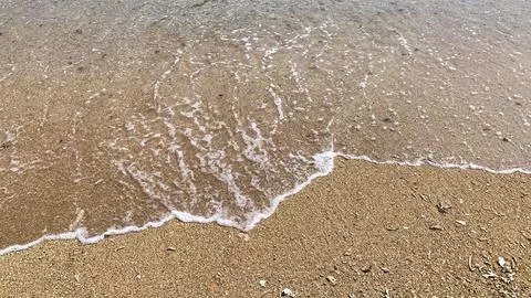 Small tiny waves lapped at the shore. Kondang Merak Beach in Malang Indonesia Stock Photos