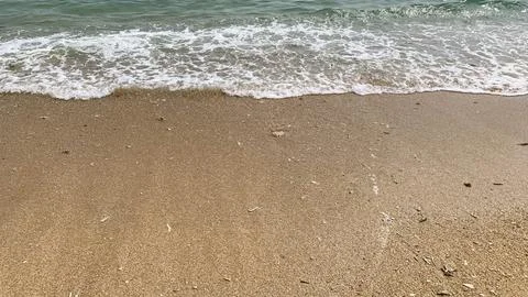 Small tiny waves lapped at the shore. Kondang Merak Beach in Malang Indonesia Stock Photos
