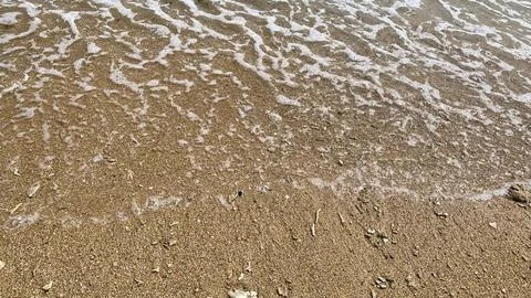 Small tiny waves lapped at the shore. Kondang Merak Beach in Malang Indonesia Stock Photos