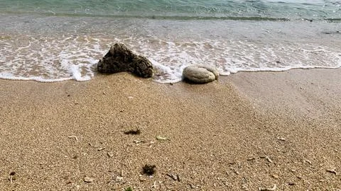 Small tiny waves lapped at the shore. Kondang Merak Beach in Malang Indonesia Stock Photos