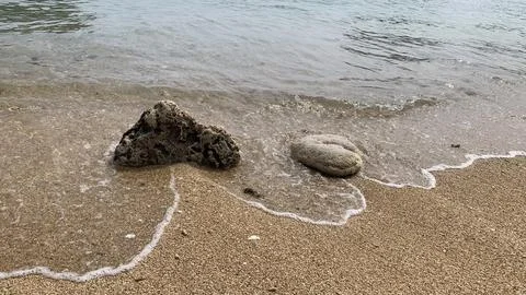Small tiny waves lapped at the shore. Kondang Merak Beach in Malang Indonesia Stock Photos