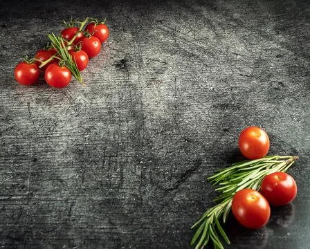 Small tomatoes on a gray background Stock Photos