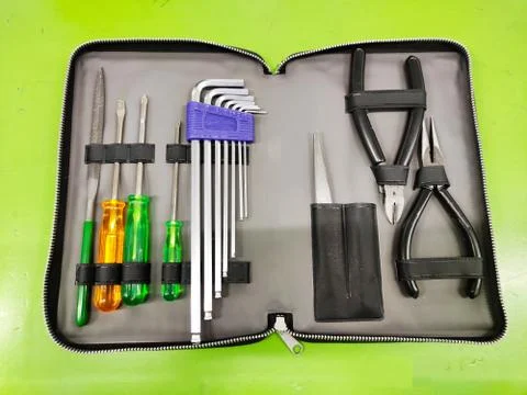 Small Tools bag open top view for Electrician and fitter with tools on a green Foto stock