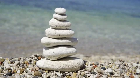Small tower made of stones. The pebbles are stacked on top of each other. Stone Stock Footage 156725672
