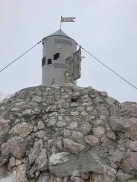 A small tower on the mountains top Stock Photos