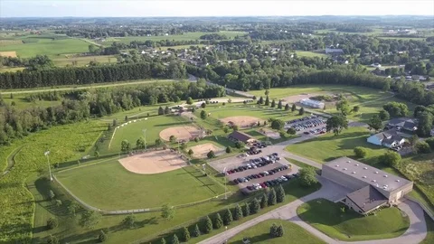 Small town baseball diamonds drone Stock Footage 77601984