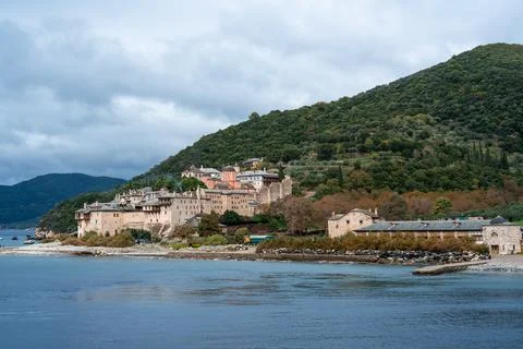 A small town with a beach and a mountain in the background Stock Photos