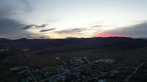 Small Town Beneath Warm Sunset Sky in Inner Mongolia, China Stock Footage 344035825