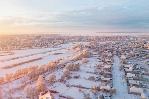 Small town covered with snow and frost in winter at dawn Stock Photos