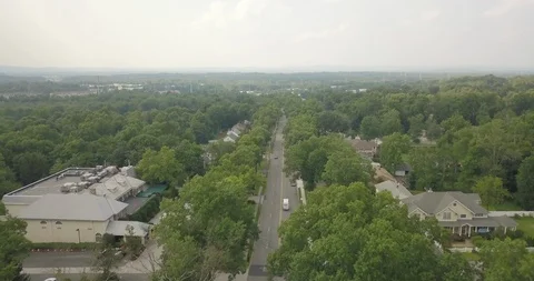 Small Town Highway trees arial moving forward straight Stock Footage 93944496