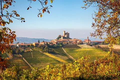 Small town on the hill as seen from the vineyards in Italy. Stock Photos