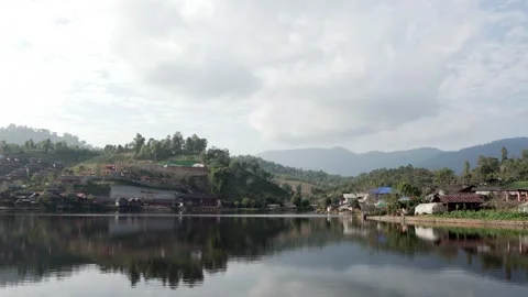 A small town with a lake in the background Stock Footage 313398309