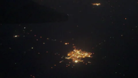 Small town lights at night under an airplane wing Stock-Footage 347983993