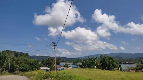 Small town with mountain and river view in Mambramo Raya Stock Footage 210295958