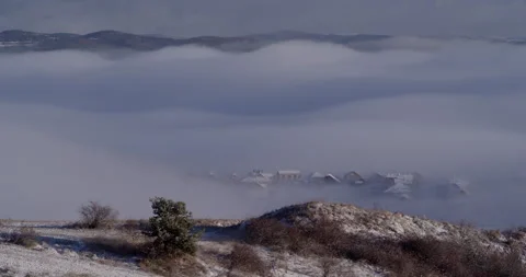 Small town in mountains covered with clouds Stock Footage 147640149