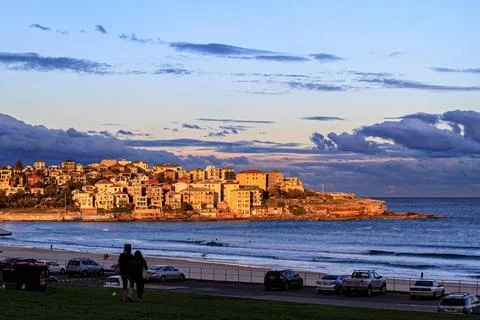 Small town by the ocean glowing under golden sunset Stock Photos