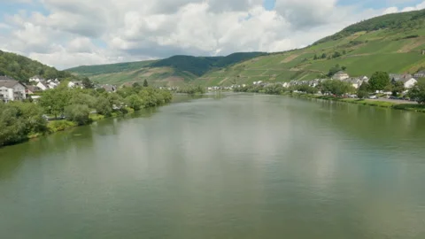 Small town by a river surrounded by mountains Video stock 140480779