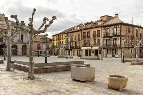 A small town square with a few trees and a few benches Stock-Fotos