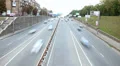 Small town street timelapse, blurry cars drive both ways, day HD Footage