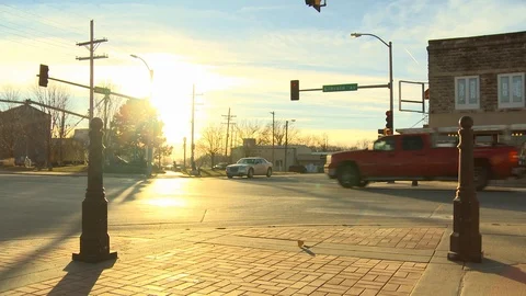 Small town traffic in evening sun Stock Footage 100048460