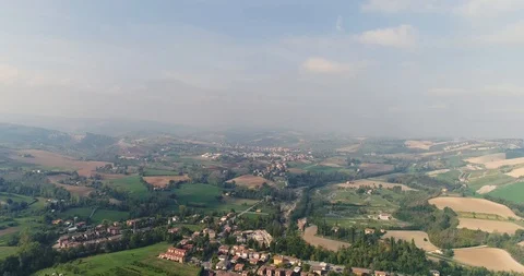 A small town in a valley between green hills, a view from above, a house near a Stock-Footage 91446570