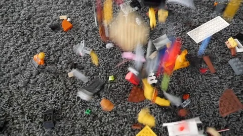 Small toy bricks falling on grey carpet slow motion Stock Footage 87479441