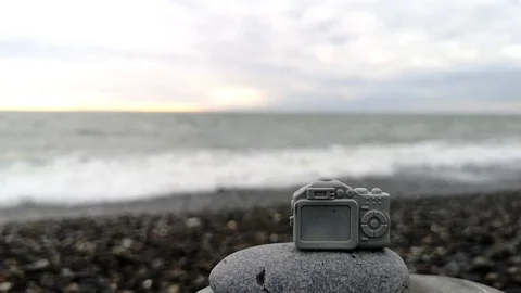 Small toy camera on the background of the sea. Stock Footage 109334524