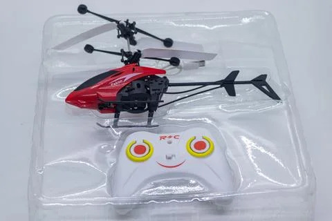 Small Toy Helicopter and Controller Set for Indoor Flying Fun in white backg Stock Photos