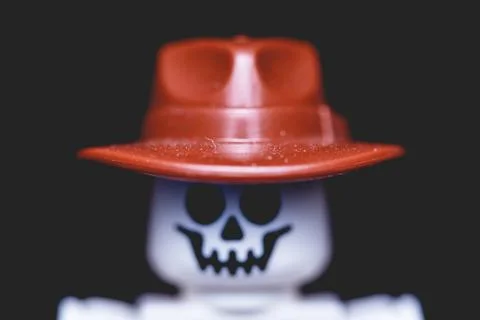 A small toy skeleton with a hat and shirt and skull face on top of it Stock Photos