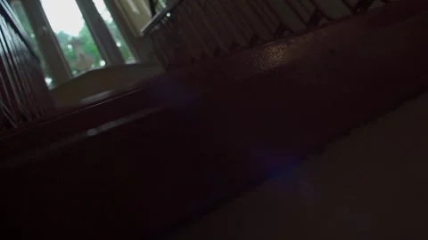 A small toy wand rolls across a staircase before tumbling down the steps.  Stock Footage 337796081