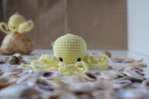 Small toy on a white background. Knitted handmade toys on a white table in the Stock Photos