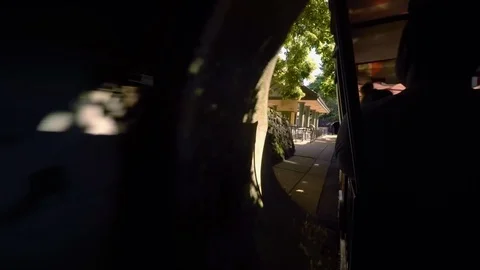 Small train comes out of a tunnel at the Saint Louis Zoo Stock-Footage 129444262