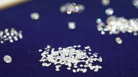 Small transparent diamonds are scattered on the blue velvet. Video stock 256479832