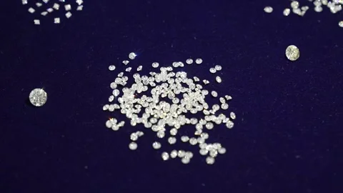 Small transparent diamonds are scattered on the blue velvet. Video stock 256479890