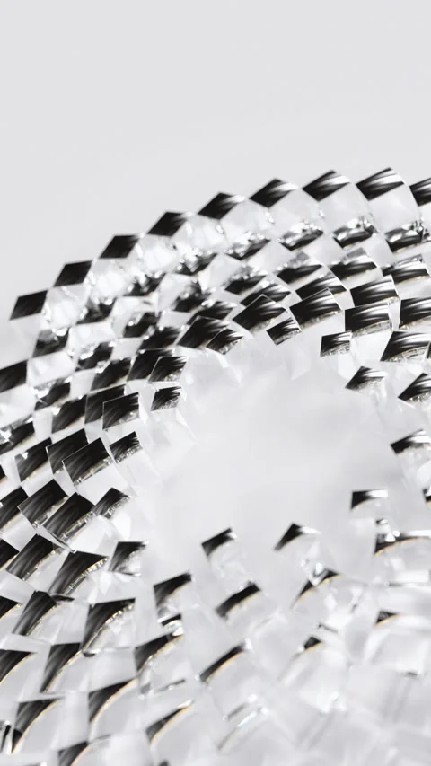 Small transparent glass cubes move in a smooth repeating circle on a clean white Stock Footage 344148440