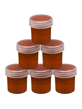 A small transparent plastic jars with brown paint for fabric or leather Stock Photos