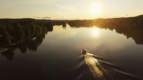 Small tree boat running beautiful at the river in summer sunset. Sweden Видео 123979840