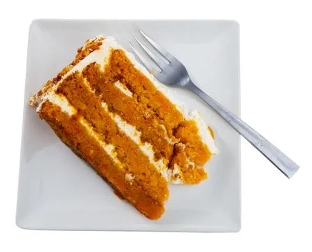 Small triangular piece of carrot cake is on plate 스톡 사진
