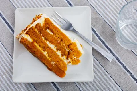 Small triangular piece of carrot cake is on plate 写真素材