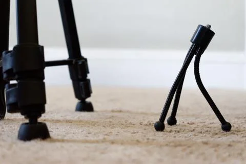 Small Tripod looking up at a Large Tripod Stock Photos