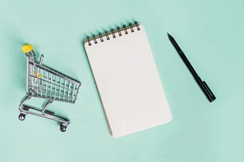 Small trolley, blank paper notepad and pen, top view. Stock Photos