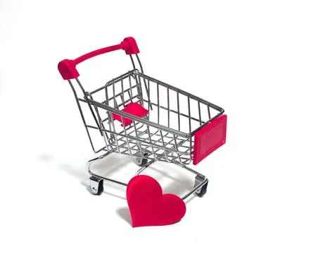 A small trolley on a white background with a red heart Stock Photos