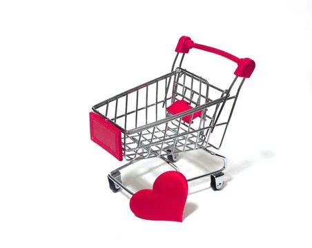 A small trolley on a white background with a red heart Stock Photos