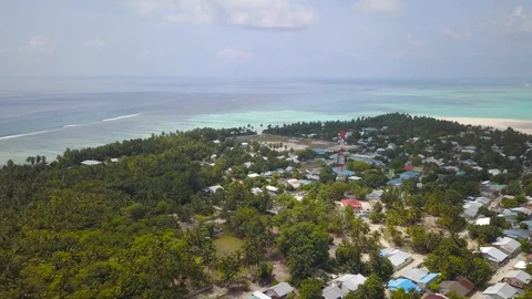 Small Tropical Island with houses of Indigenous People in Maldives form above Stock Footage