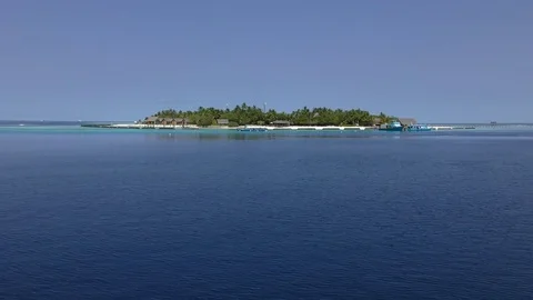 Small tropical island in Indian Ocean, calmnice blue sky & soft white clouds, Stock Footage